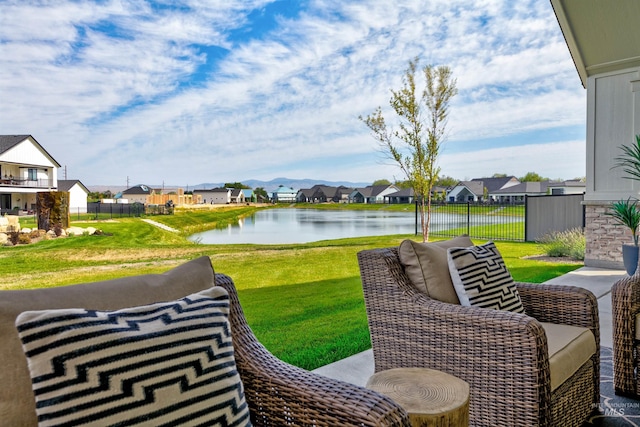 view of patio with a residential view and a water view