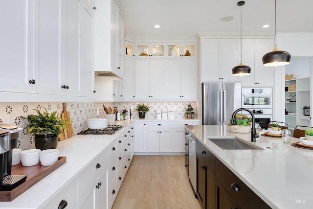 kitchen with appliances with stainless steel finishes, a sink, white cabinetry, and recessed lighting