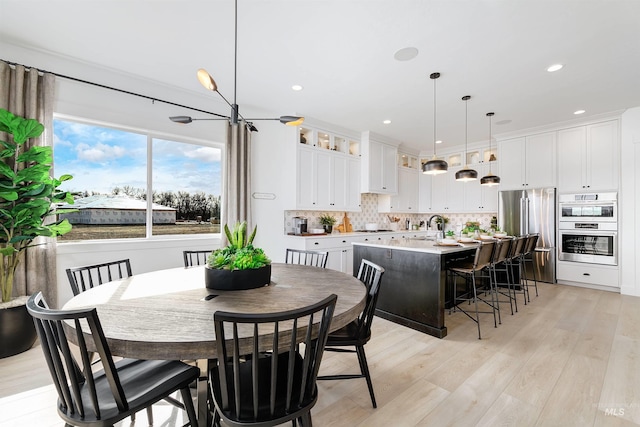 dining space featuring light wood finished floors