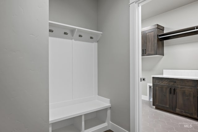 mudroom with baseboards and light tile patterned floors