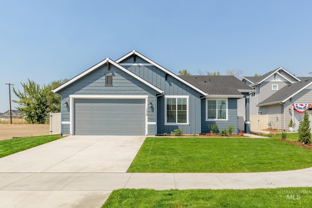 view of front of home with fence, an attached garage, a front lawn, concrete driveway, and board and batten siding