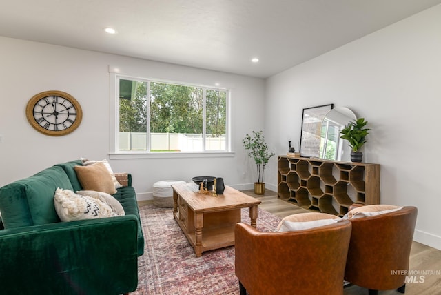 living area with recessed lighting, baseboards, and wood finished floors