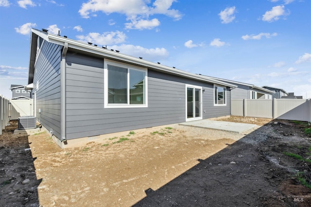 back of property with a patio area, central AC, and a fenced backyard