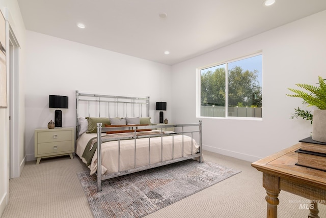 bedroom featuring recessed lighting, light colored carpet, and baseboards