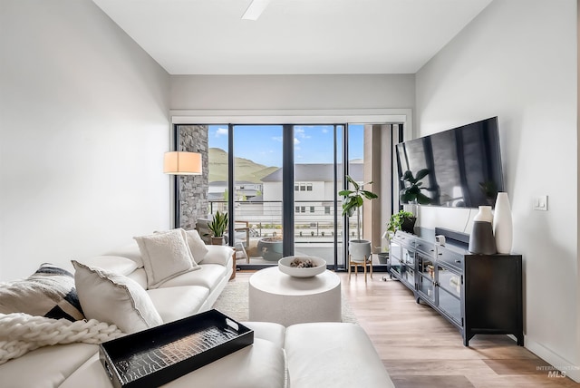 living room featuring light wood-style floors and baseboards