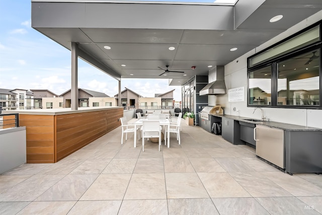 view of patio featuring grilling area, ceiling fan, exterior kitchen, outdoor dining area, and a sink