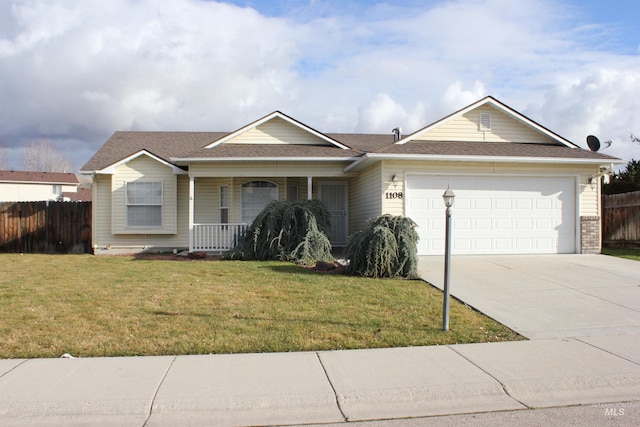 ranch-style home featuring a front lawn, covered porch, and a garage