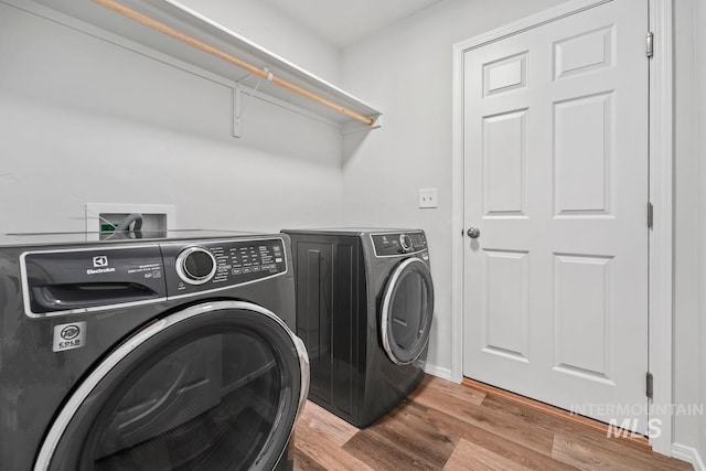 12740 Abbeygate Dr, Nampa, ID 83651 - washroom featuring separate washer and dryer and light wood finished floors
