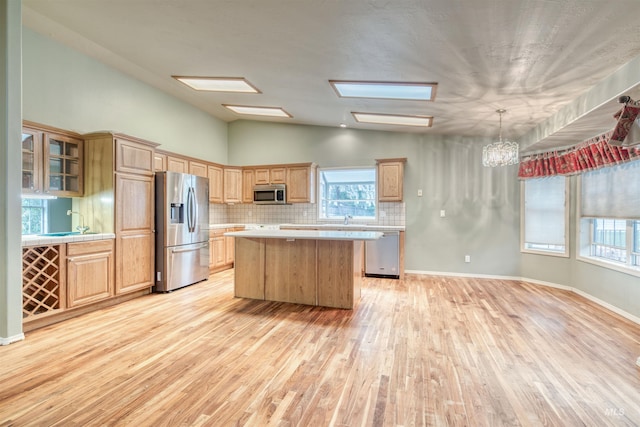 1921 Arcata Way, Ontario, OR 97914 - kitchen with appliances with stainless steel finishes, light countertops, a kitchen island, light wood-style flooring, and lofted ceiling
