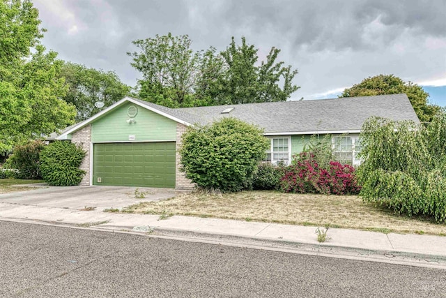 1921 Arcata Way, Ontario, OR 97914 - view of front of house with an attached garage, brick siding, and concrete driveway