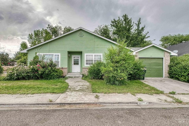 1921 Arcata Way, Ontario, OR 97914 - view of front of house with brick siding, driveway, a garage, and a front yard