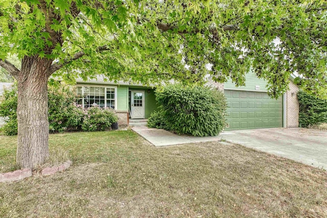 1921 Arcata Way, Ontario, OR 97914 - view of property hidden behind natural elements with brick siding, concrete driveway, a front yard, an attached garage, and entry steps
