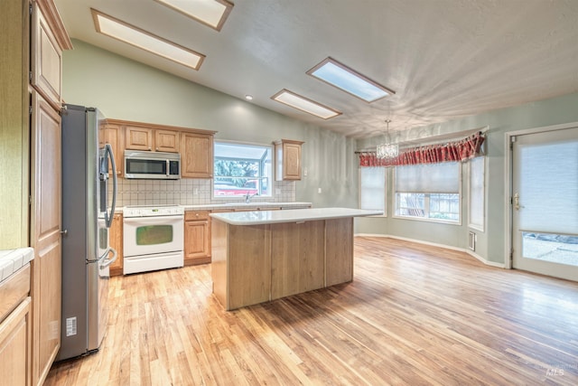 1921 Arcata Way, Ontario, OR 97914 - kitchen with stainless steel appliances, light countertops, a center island, tasteful backsplash, and lofted ceiling