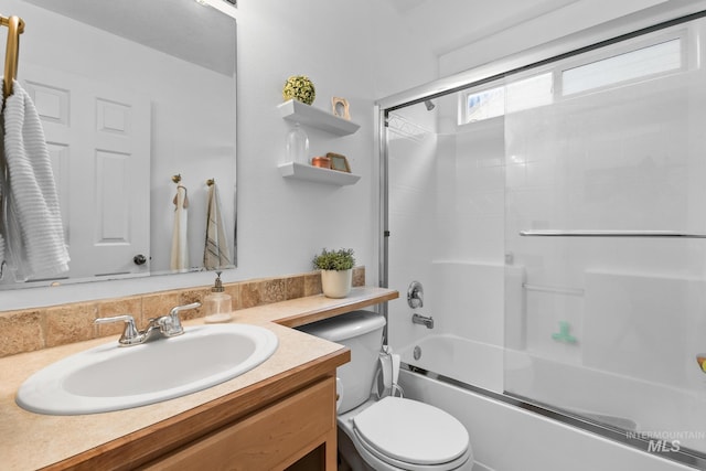 full bathroom with shower / bath combination with glass door, vanity, and toilet