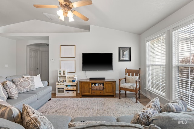 living room with ceiling fan, light hardwood / wood-style floors, and lofted ceiling