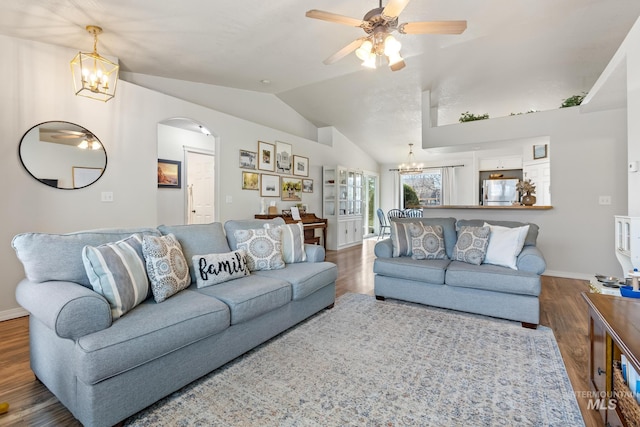 living room with hardwood / wood-style flooring, ceiling fan with notable chandelier, and vaulted ceiling