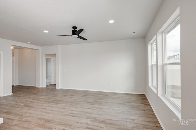 spare room with ceiling fan, light wood finished floors, recessed lighting, and baseboards