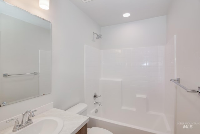 full bath featuring vanity, bathtub / shower combination, and toilet