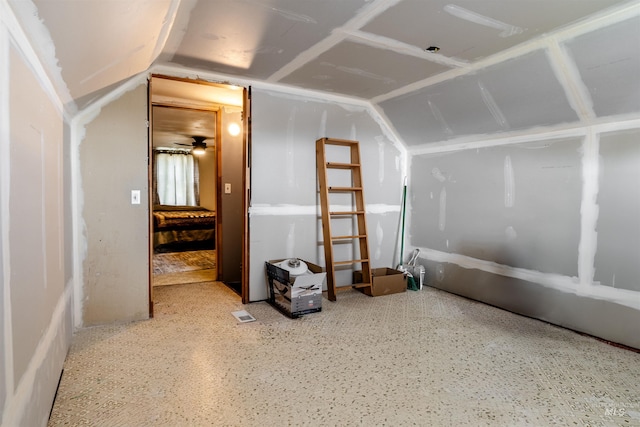 additional living space featuring ceiling fan and lofted ceiling