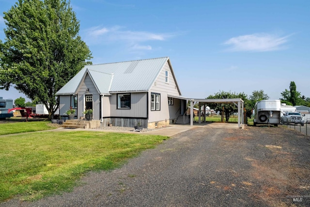 view of front facade with a front yard and a carport