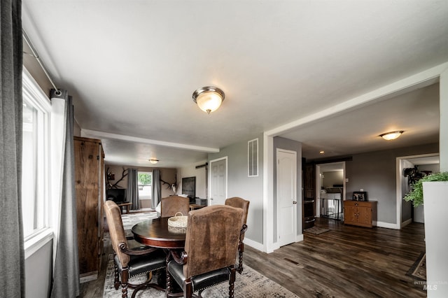 dining space with dark wood-type flooring