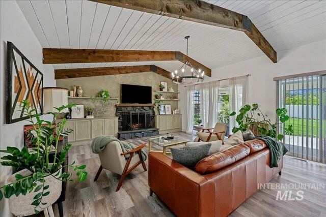 15103 Castle Way, Caldwell, ID 83607 - living room with a chandelier, wood finished floors, wooden ceiling, and a stone fireplace