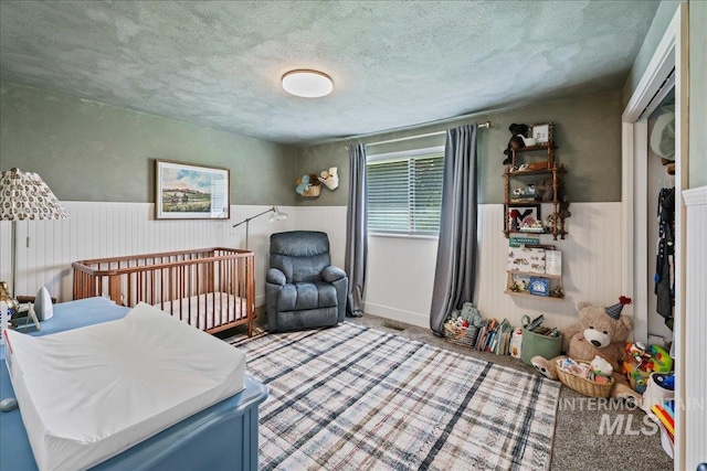 15103 Castle Way, Caldwell, ID 83607 - carpeted bedroom featuring wainscoting and a textured ceiling