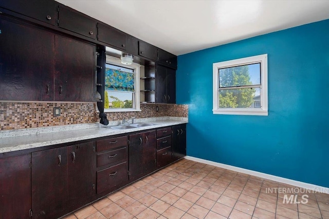 359 Falls Ave W, Twin Falls, ID 83301 - kitchen featuring a sink, tasteful backsplash, light countertops, baseboards, and light tile patterned floors