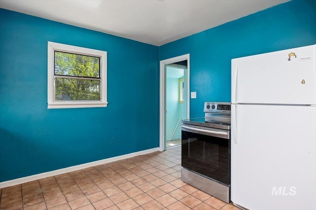 359 Falls Ave W, Twin Falls, ID 83301 - kitchen with freestanding refrigerator, electric stove, baseboards, and light tile patterned floors