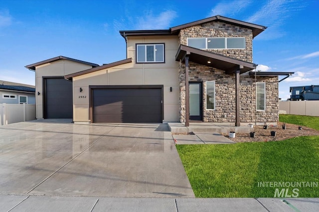 6150 S Binky Ave, Meridian, ID 83642 - contemporary home with stone siding, stucco siding, driveway, and a garage