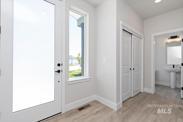 6150 S Binky Ave, Meridian, ID 83642 - entryway with light wood-type flooring, baseboards, and recessed lighting