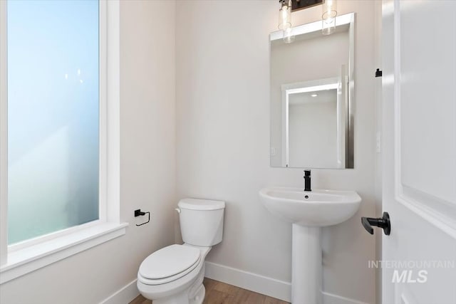 6150 S Binky Ave, Meridian, ID 83642 - half bath featuring toilet, baseboards, and wood finished floors