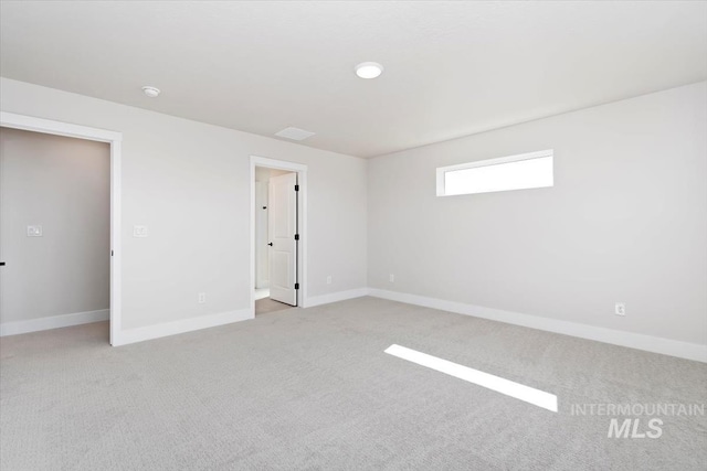 6150 S Binky Ave, Meridian, ID 83642 - spare room featuring light colored carpet, baseboards, and a smoke detector