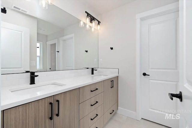 6150 S Binky Ave, Meridian, ID 83642 - bathroom featuring double vanity and baseboards