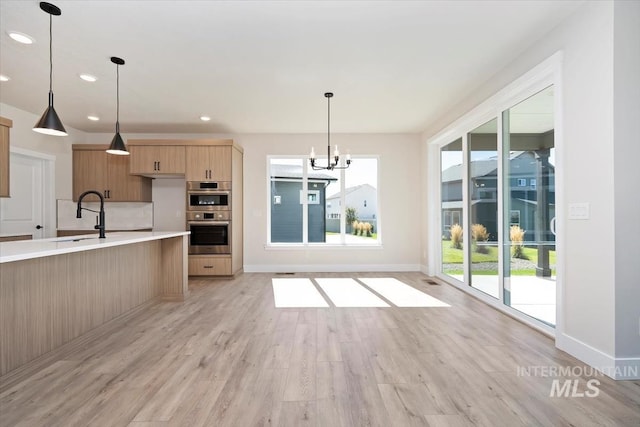 6150 S Binky Ave, Meridian, ID 83642 - kitchen with a sink, double oven, healthy amount of natural light, light countertops, and recessed lighting