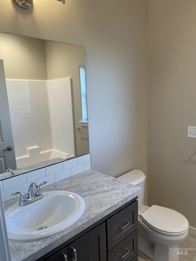 bathroom with tile patterned floors, toilet, and vanity