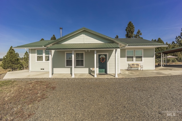 view of front facade with a porch and metal roof