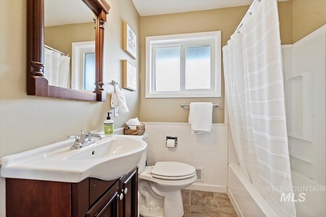 full bathroom featuring toilet, shower / bath combination with curtain, and vanity