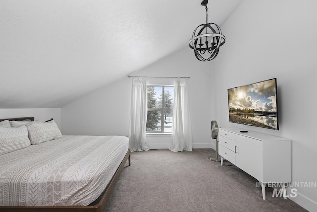 bedroom featuring carpet floors, an inviting chandelier, and vaulted ceiling