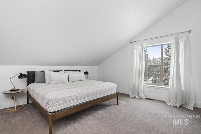 bedroom with carpet, multiple windows, and lofted ceiling