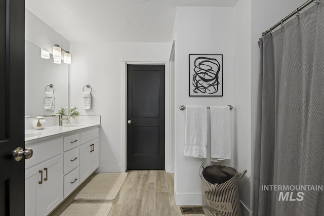 bathroom featuring hardwood / wood-style floors and vanity