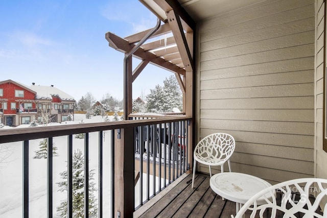 view of snow covered back of property