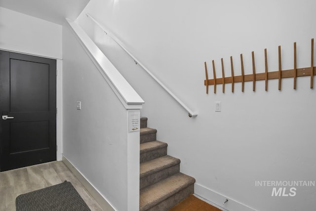 stairs with hardwood / wood-style flooring