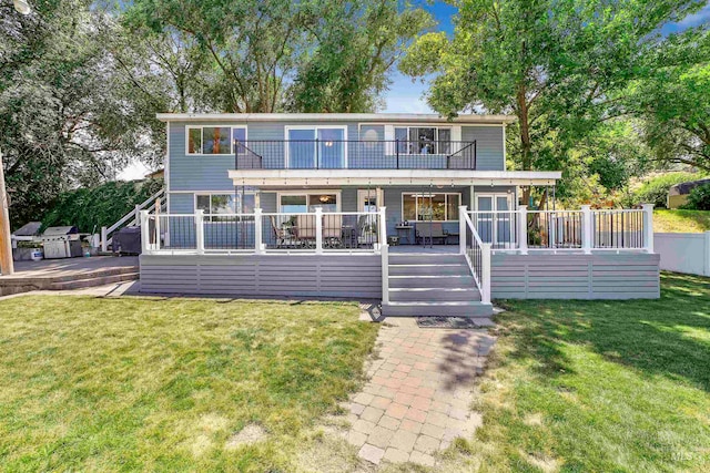 view of front facade featuring a front lawn and a wooden deck