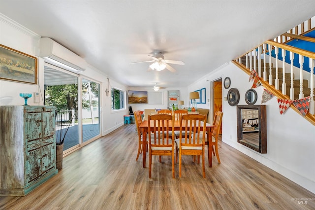 dining room with light hardwood / wood-style flooring, ceiling fan, ornamental molding, and a wall mounted AC