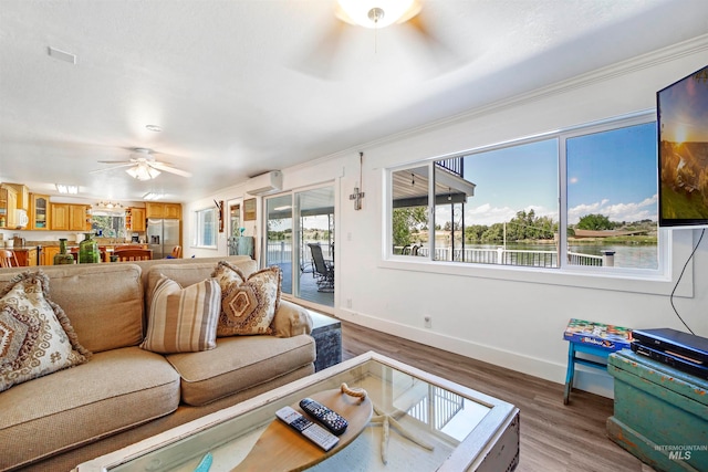 living room with a wall mounted AC, ceiling fan, and hardwood / wood-style flooring