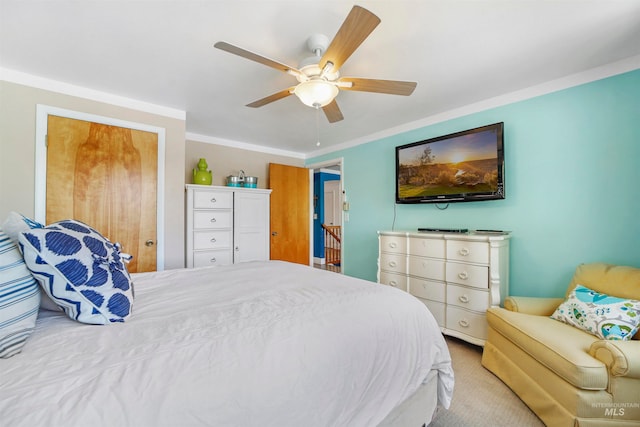 bedroom with ceiling fan, light colored carpet, and crown molding