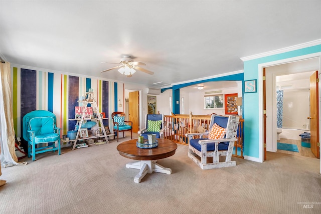 carpeted living room with ceiling fan and crown molding