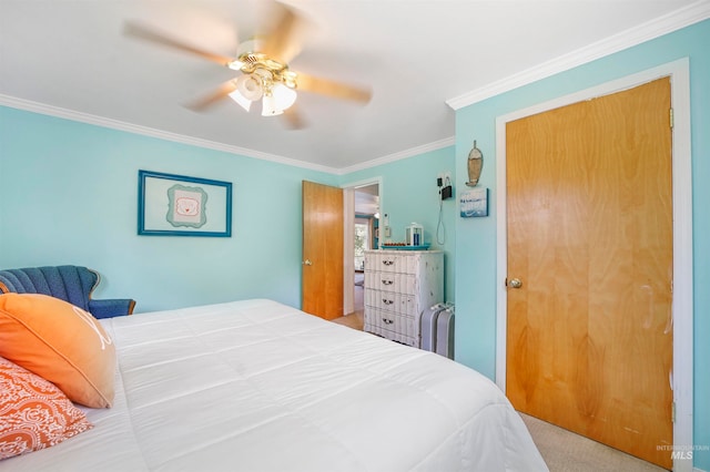 carpeted bedroom featuring ceiling fan and ornamental molding