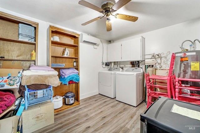 laundry room featuring ceiling fan, a wall mounted AC, cabinets, separate washer and dryer, and light hardwood / wood-style floors